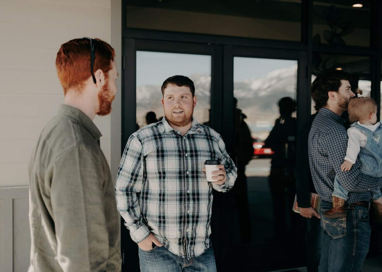 Two men talking outside of Emmaus Road Church in Bozeman, MT